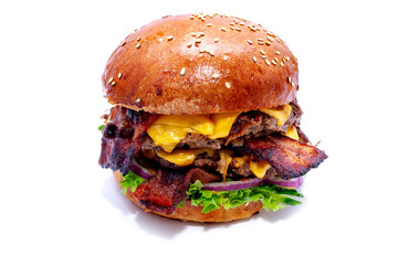 Juicy beef burger with bacon, cheese and salad. Close-up.