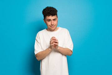 Young man over blue background scheming something