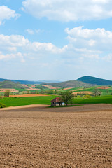 Fototapeta premium Field and green mountains view at sunny day