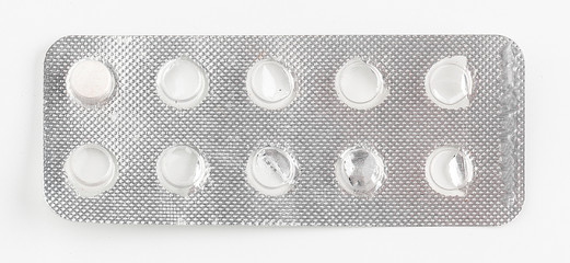 Silver blister packs pills isolated on white