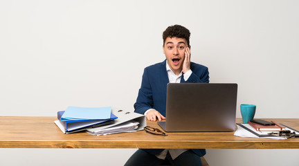 Business man in a office with surprise and shocked facial expression