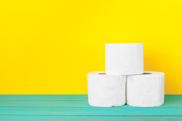 Toilet paper stacks  on bright yellow background
