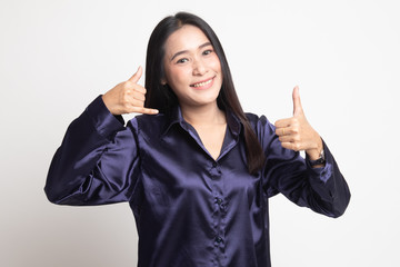 Young Asian woman thumbs up show with phone gesture.