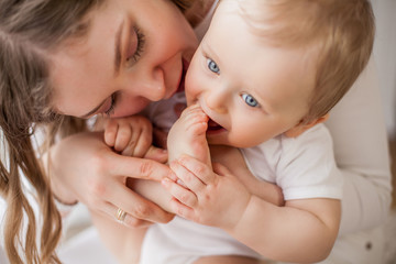 Close-up. Beautiful mother and little son 9 months in the home interior. Cozy. Baby. Motherhood.