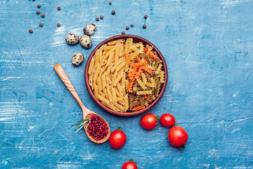 Italian pasta in plate on a blue wooden table
