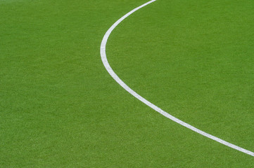 Artificial green turf texture background with white line marks