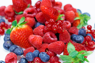assorted fresh berries with white background