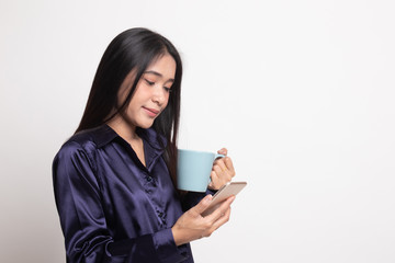 Young Asian woman with mobile phone and coffee cup.