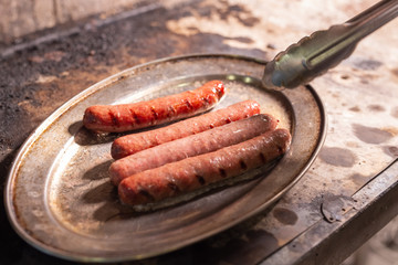 food, delicious and meat concept - roasting horse meat sausages grilled.