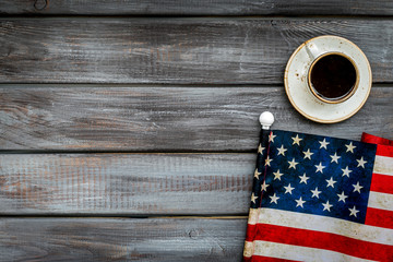 Independence day of USA with flag and cup of coffee on gray wooden background top view space for text