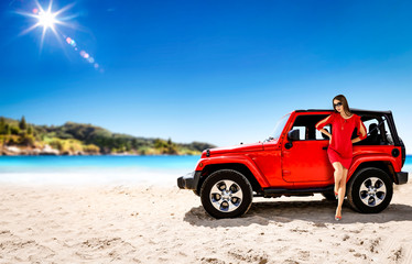 Fototapeta na wymiar Slim young woman in summer dress and red car on beach. Free space for your decoration. 