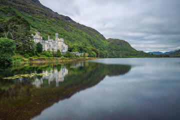 Fototapeta na wymiar Kylemore Abbey in Ireland with reflections in the Pollacapall Lough