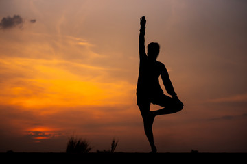 Silhouette Asia woman yoga on sunset. - Image