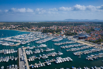 Fototapeta premium Aerial View of Yacht Club and Marina in Biograd na Moru. Summer time in Dalmatia region of Croatia. Coastline and turquoise water and blue sky. Photo made by drone from above.