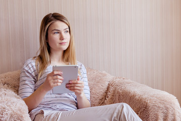 Young woman at home with tablet device