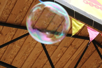 soap bubble soars up to the ceiling