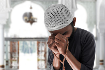 Religious muslim man praying in mosque