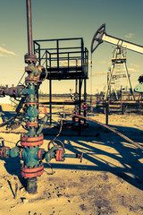 Oil wellhead with valve armature. Oil and gas industry theme. Petroleum concept.