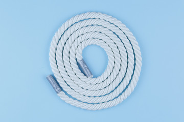 rope on a blue background, a katana twisted on a table