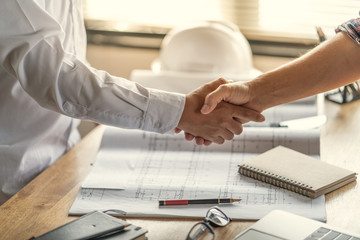 Officer teamwork is happy and shake hands to celebrate in success of finish in job planning about...