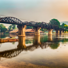 The bridge on the river Kwai at sunrise. Railway in Kanchanaburi, Thailand