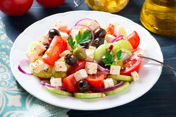 Authentic greek salad on a blue background