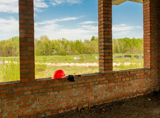 A pair of gloves and a Mason's helmet at the construction.