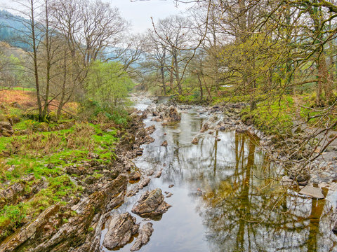 The rock strewn  River Mawddach in Gwynedd on a hazy spring day in Cymru.