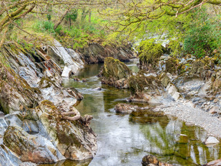 Rocks of all shapes and sizes line the banks and riverbed of the  River Mawddach in Cymru.