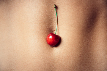Love game. Fit woman body. Cherry fruit. Sensual concept. Sexuality. Beautiful girl. Hot Sexy detail of a girl body. Naked sensual beautiful girl. Summer fruit. Erotic couple. Beautiful Female Body