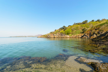 A small cove on the River Dwyryd estuary under a blue spring sky in Cymru.