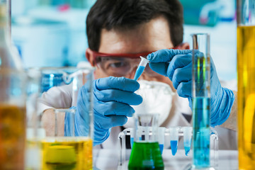 Researcher holding tube pcr in the laboratory /Chemist engineer holding test tube in the investigation lab