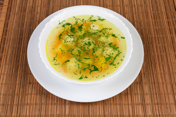Chicken meatballs soup in the white dish