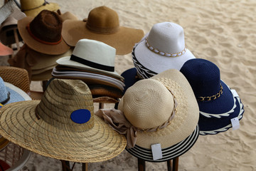 Various womens hats are lined for sale