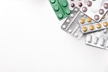 pills in blister packs on white background with copyspace