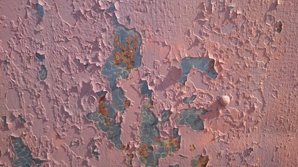 old cracked red paint on an iron wall
