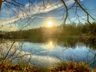 Tranquil idyllic lake landscape at sunset