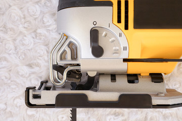 Mode adjustment electric jigsaw machine on a white background. Woodworking tools for industry and...