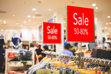 Obraz premium Sale 50-80% off mock up advertise display at clothes line in the shopping department store. Shopping concept.