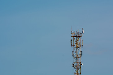Telecommunication 5G tower on blue sky blank background. Used to transmit television and telephony signal