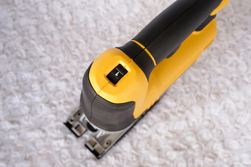 Speed set control electric jigsaw machine on a white background. Woodworking tools for industry and...