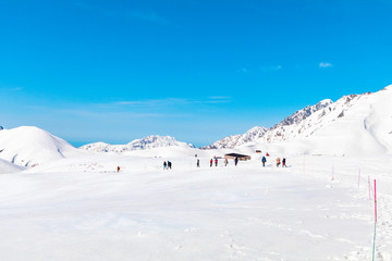 The japan alps  or the snow mountains wall  of Tateyama Kurobe alpine  in sunshine day with  blue sky background is one of the most important and popular natural place in Toyama Prefecture, Japan.