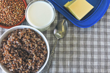 Buckwheat porridge with milk and butter. The concept of a healthy breakfast or snack. Healthy food. Eco food.