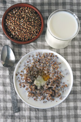 Buckwheat porridge with milk and butter. The concept of a healthy breakfast or snack. Healthy food. Eco food.
