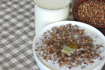 Buckwheat porridge with milk and butter. The concept of a healthy breakfast or snack. Healthy food. Eco food.