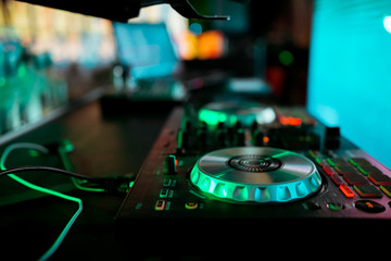 Obraz premium DJ mixing music on console at the night club