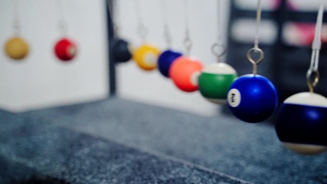 Newton's cradle showing laws of physics in motion.
