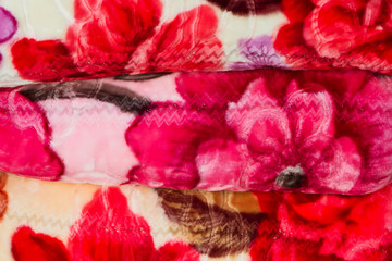 Stack of colorful blankets together.