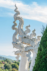white serpent head of naga statue on blue sky background.