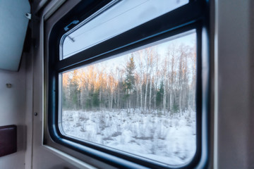 View of the window of a moving passenger train.